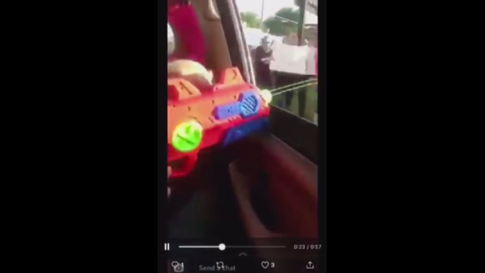 Screenshot of teen spraying liquid at protesters